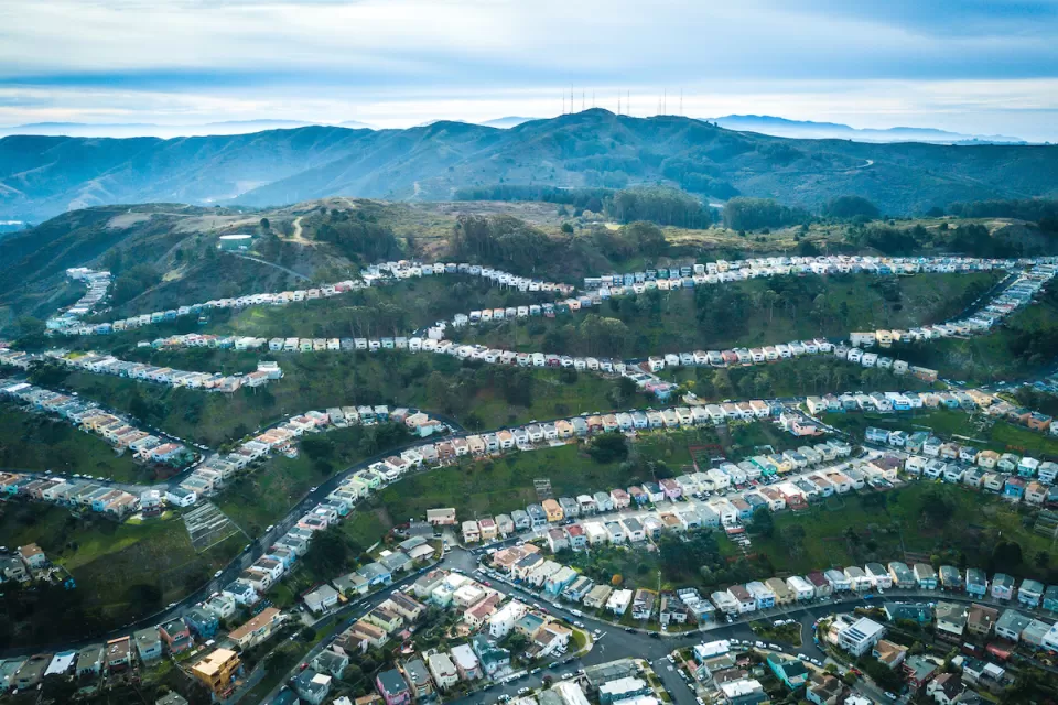 Aerial view of homes on green hillsides in Daly City, California.